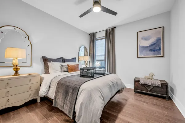 a bedroom with bed and a chandelier