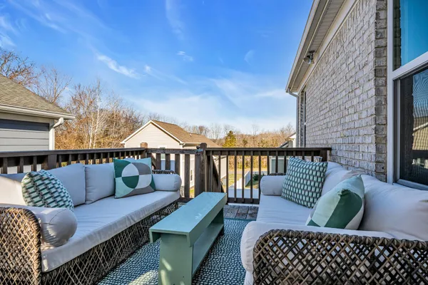 a roof deck with couches and wooden floor