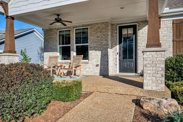 a view of a patio with table and chairs and potted plants