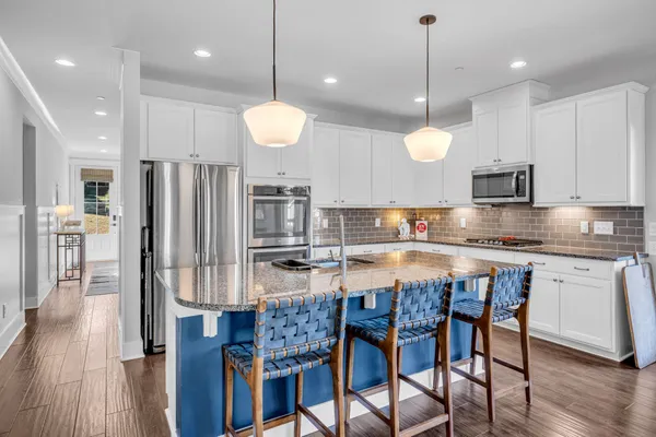 a large kitchen with a table and chairs