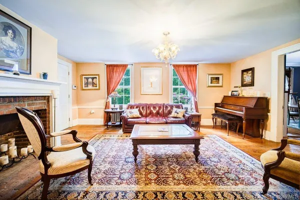 a living room with fireplace furniture and a rug