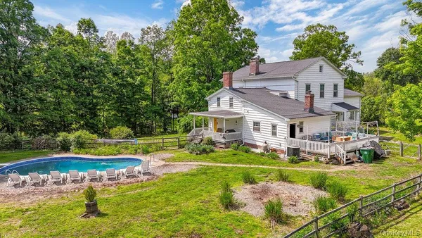 a aerial view of a house with swimming pool and a yard