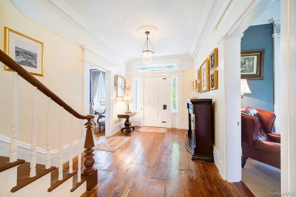 a view of an entryway with wooden floor and stairs