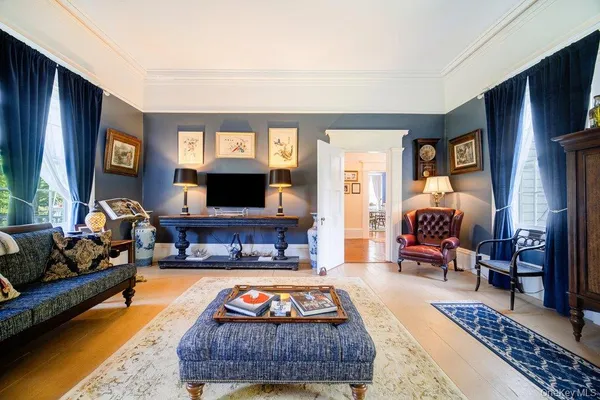 a living room with furniture a flat screen tv and a fireplace