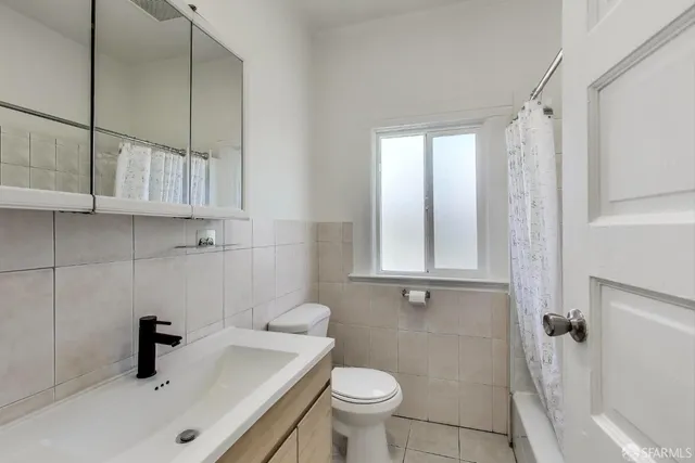 a bathroom with a sink a toilet and bathtub