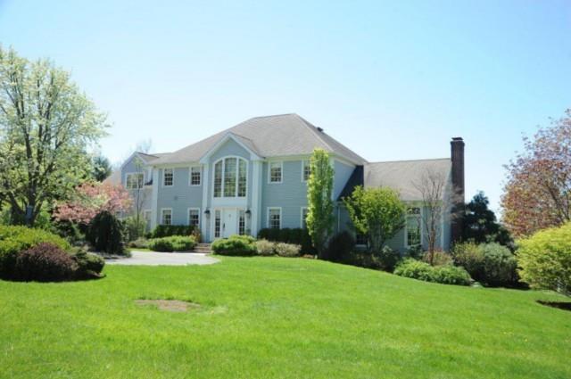 65 Georges Hill Road Newtown, CT 06470 - Photo 1 of 1 a front view of a house with a yard and trees