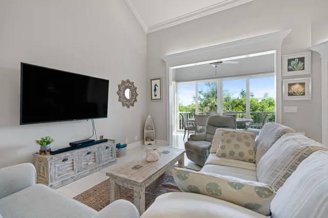 a living room with furniture and a floor to ceiling window