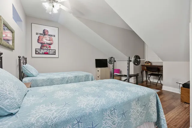 a bedroom with two beds and a chandelier
