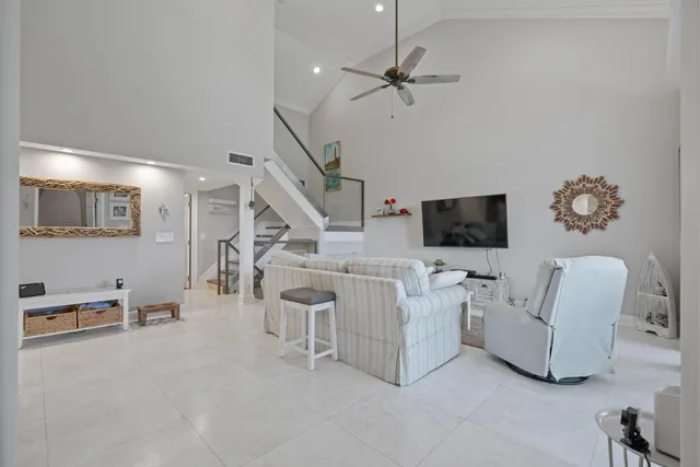 a living room with furniture and view of kitchen