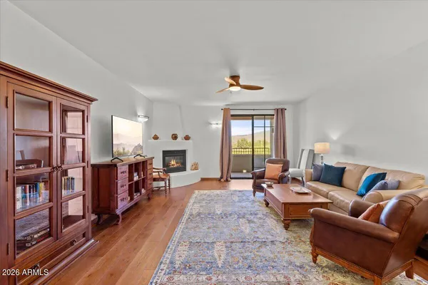 a living room with furniture a fireplace and a window