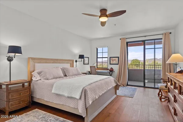 a bedroom with a large bed and a large window