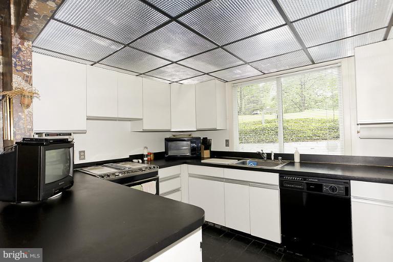 16215 Comus Road Clarksburg, MD 20871 - Photo 14 of 29 a kitchen with a sink a window cabinets and appliances