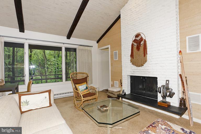16215 Comus Road Clarksburg, MD 20871 - Photo 7 of 29 a living room with furniture a fireplace and a floor to ceiling window
