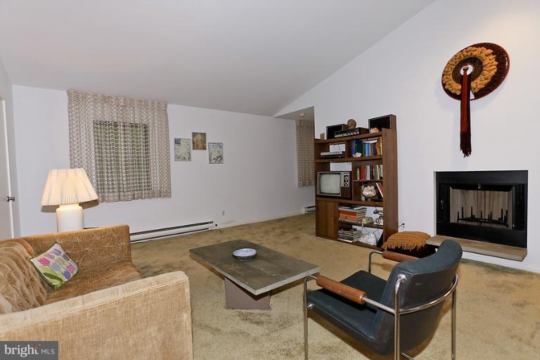 16215 Comus Road Clarksburg, MD 20871 - Photo 9 of 29 a living room with furniture and a lamp