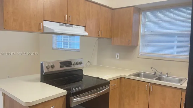 a kitchen with a sink cabinets and appliances
