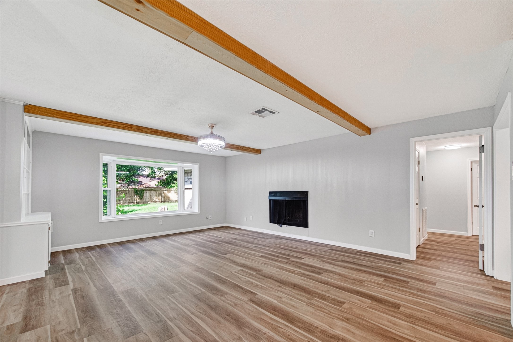 25503 Foxbriar Lane Spring, TX 77373 - Photo 19 of 45 a view of an empty room with wooden floor and a window