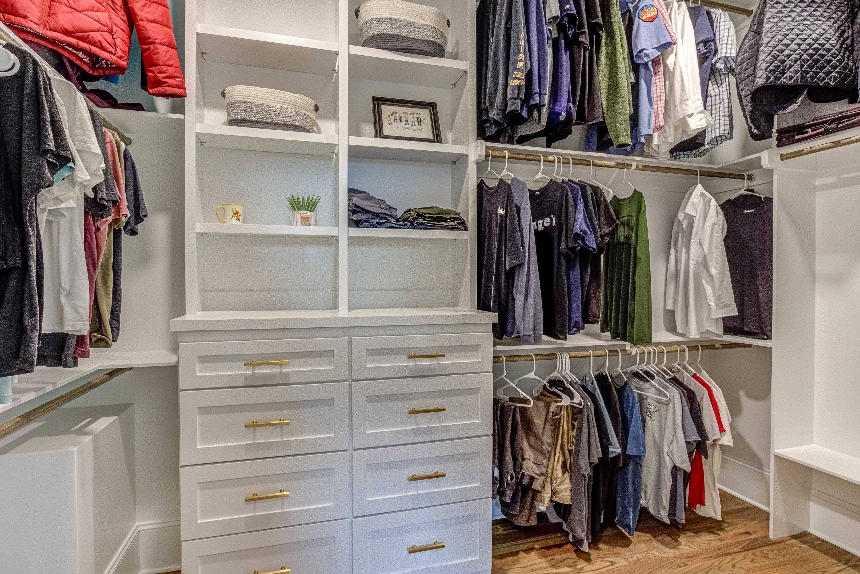 109 Independence Drive Smithfield, NC 27577 - Photo 20 of 36 a view of walk in closet with clothes and shoes