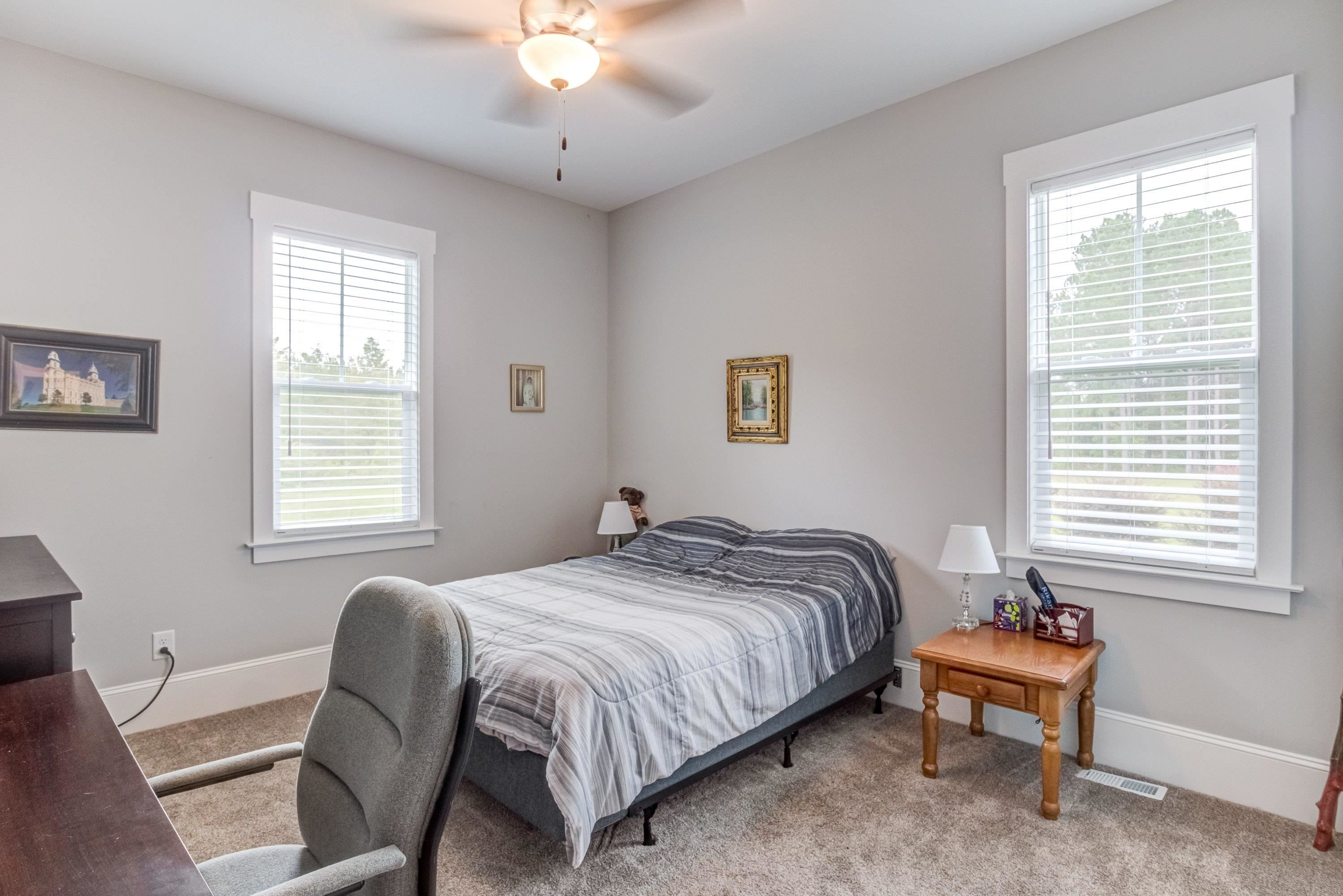 109 Independence Drive Smithfield, NC 27577 - Photo 22 of 36 a bedroom with a bed and a chair