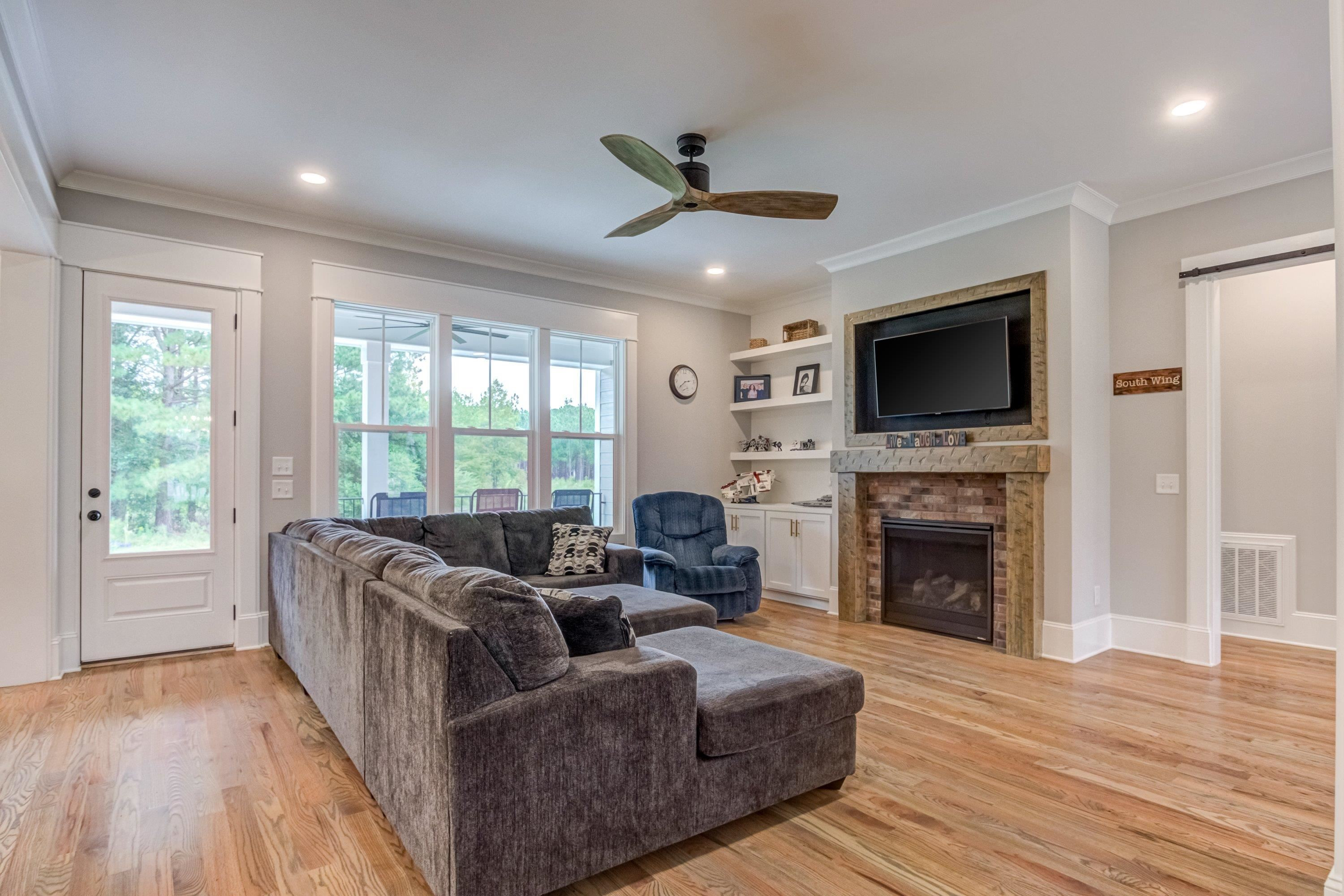 109 Independence Drive Smithfield, NC 27577 - Photo 7 of 36 a living room with furniture a flat screen tv and a fireplace
