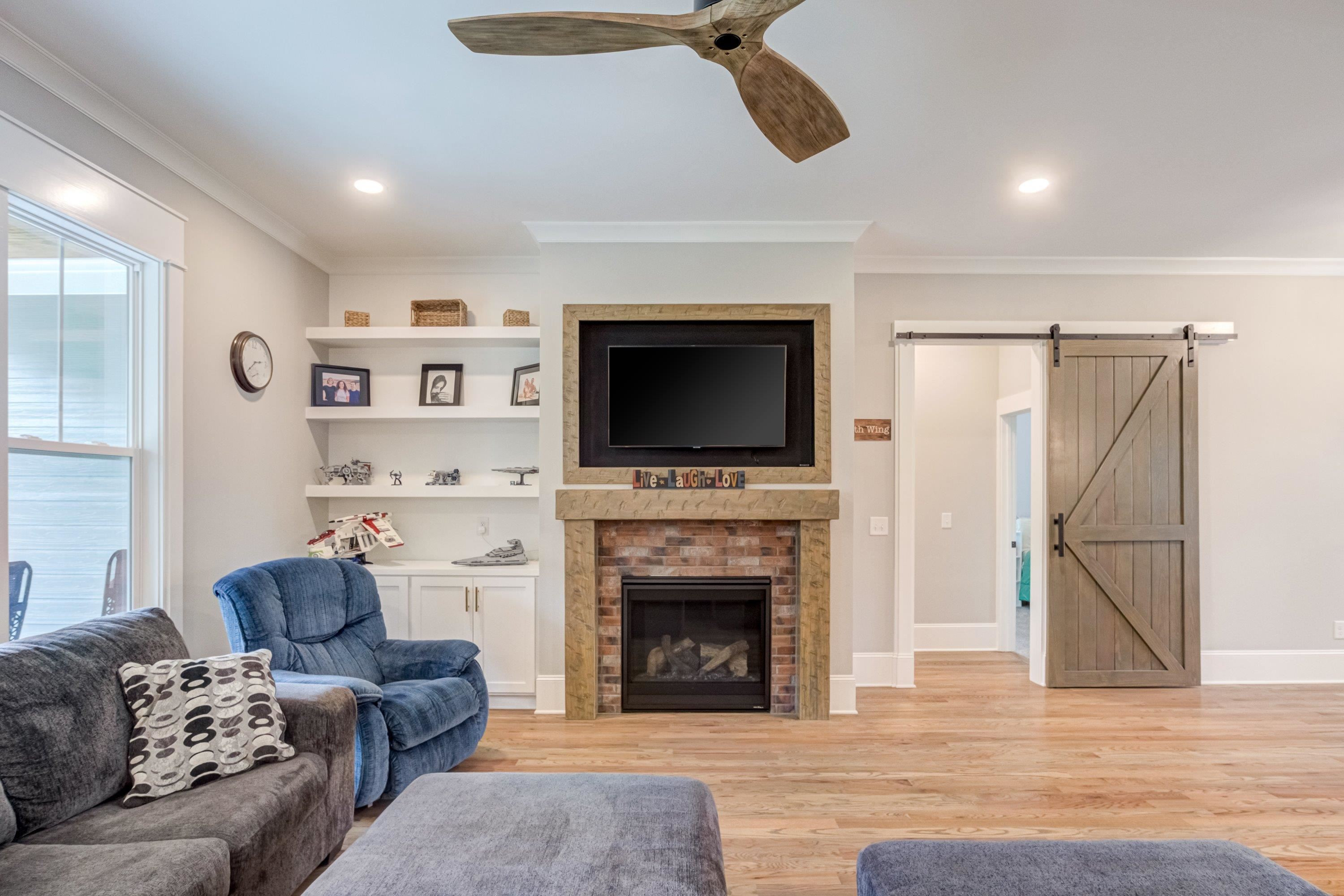 109 Independence Drive Smithfield, NC 27577 - Photo 8 of 36 a living room with furniture a flat screen tv and a fireplace