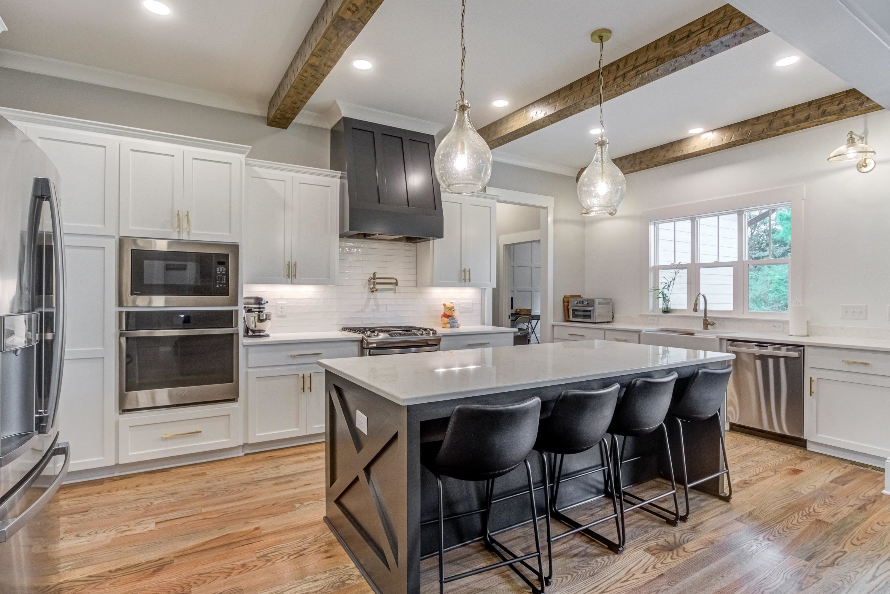 109 Independence Drive Smithfield, NC 27577 - Photo 9 of 36 a kitchen with stainless steel appliances a stove a sink a microwave a dining table and chairs