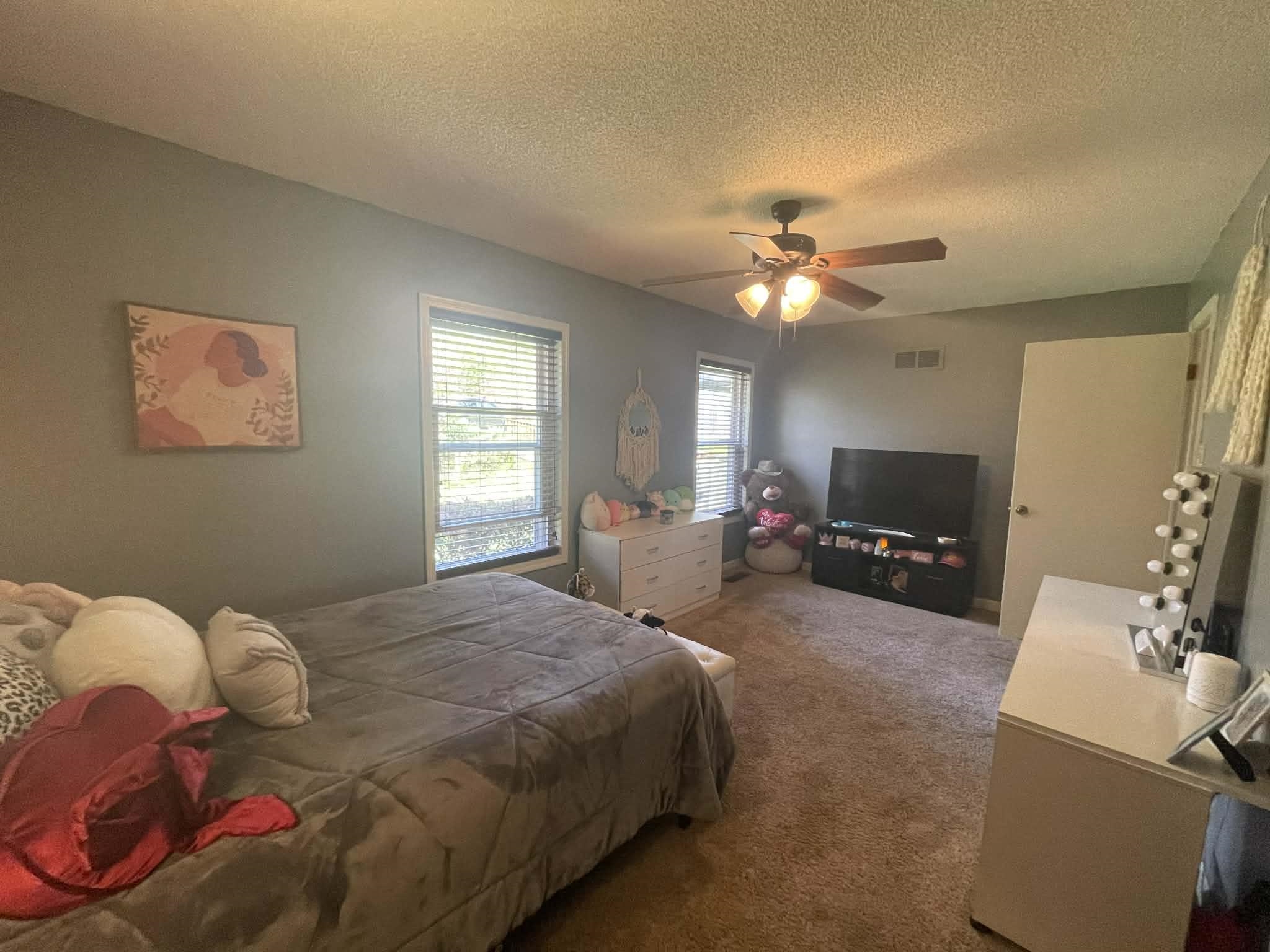 1655 Country Club Road Somerville, TN 38068 - Photo 17 of 26 a spacious bedroom with a bed and a chandelier