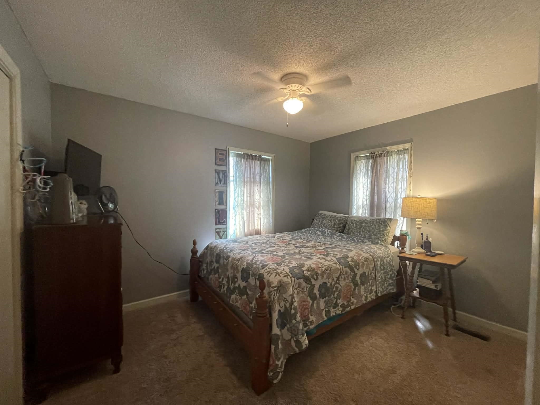 1655 Country Club Road Somerville, TN 38068 - Photo 20 of 26 a bed sitting in a bedroom next to a window and a lamp