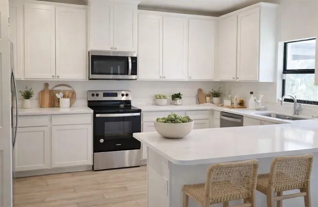 a kitchen with a sink a stove and cabinets