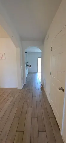 a view of a room with wooden floor and a sink