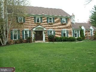 571 Gulph Road Wayne, PA 19087 - Photo 1 of 6 a front view of a house with a garden