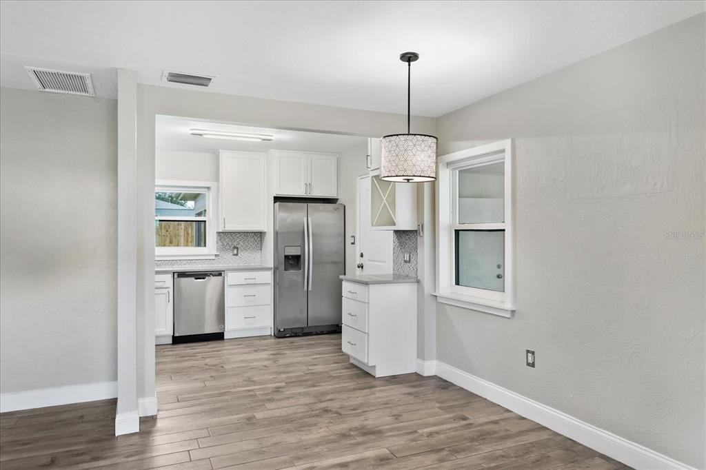 916 Timor Avenue Orlando, FL 32804 - Photo 15 of 60 a kitchen with refrigerator a sink cabinets and wooden floor