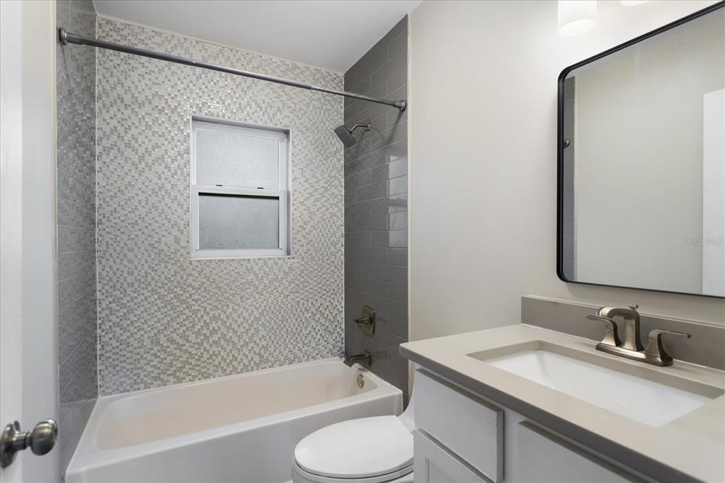 916 Timor Avenue Orlando, FL 32804 - Photo 16 of 60 a bathroom with a granite countertop sink toilet and shower