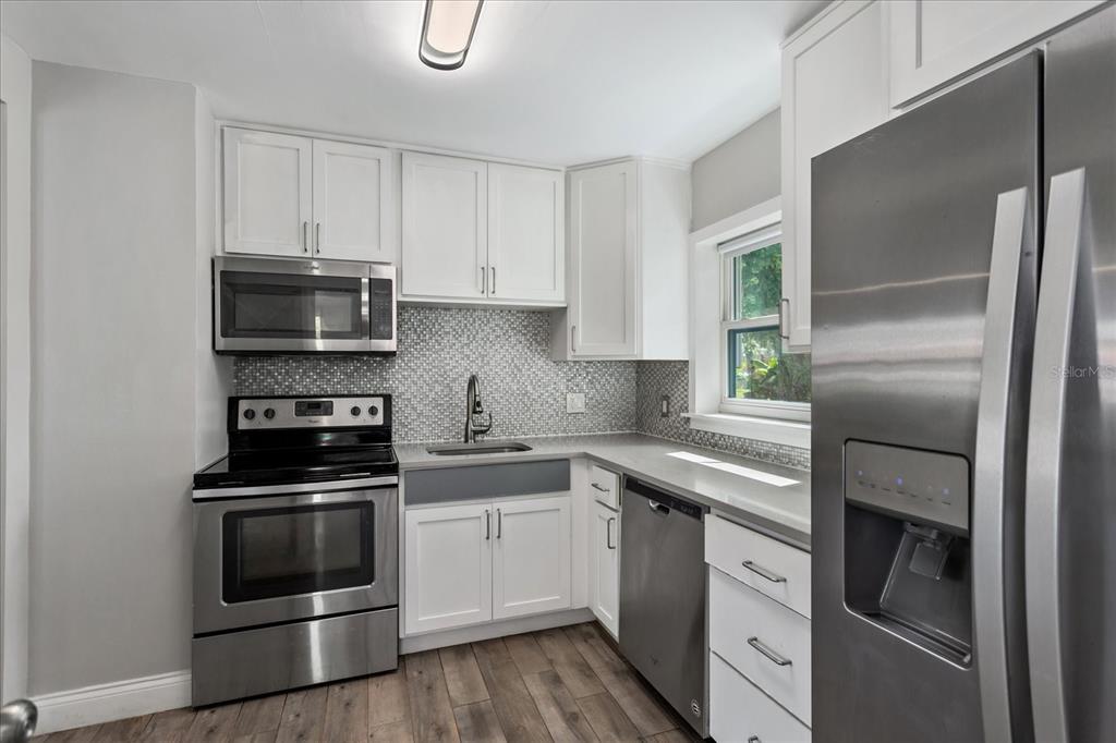 916 Timor Avenue Orlando, FL 32804 - Photo 2 of 60 a kitchen with a sink stove and refrigerator