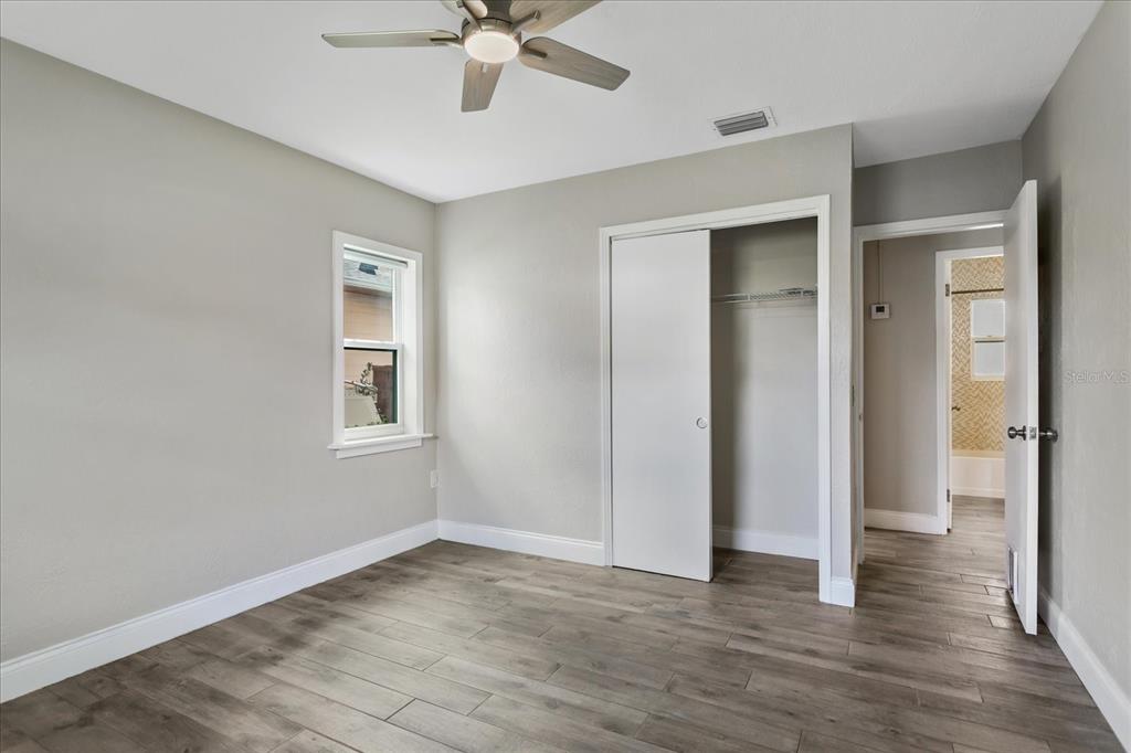 916 Timor Avenue Orlando, FL 32804 - Photo 21 of 60 an empty room with wooden floor fan and windows