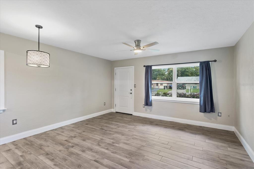 916 Timor Avenue Orlando, FL 32804 - Photo 7 of 60 a view of an empty room with a window and wooden floor
