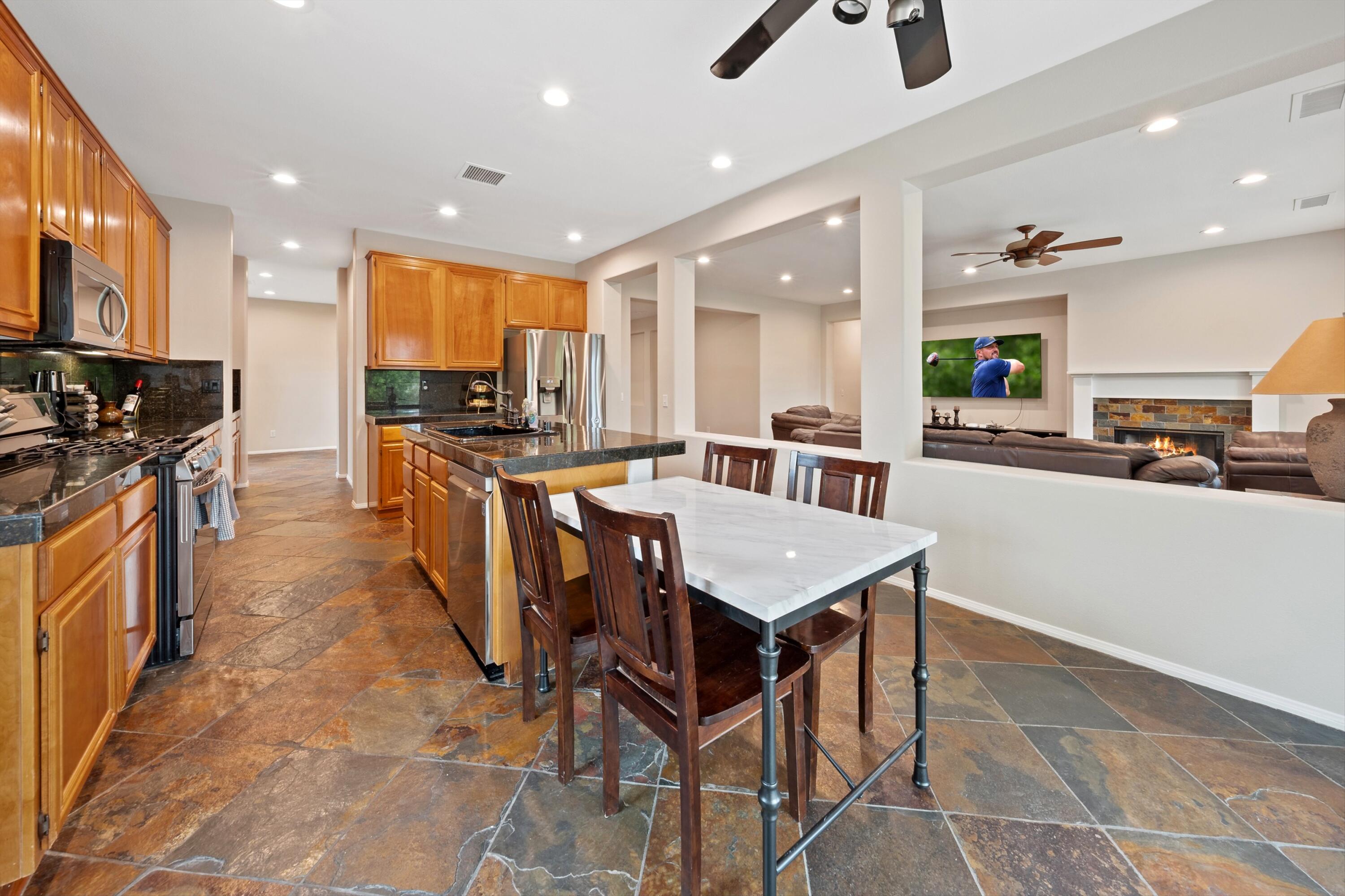 49335 Douglas Street Indio, CA 92201 - Photo 19 of 31 a kitchen with stainless steel appliances granite countertop a sink a stove and a refrigerator