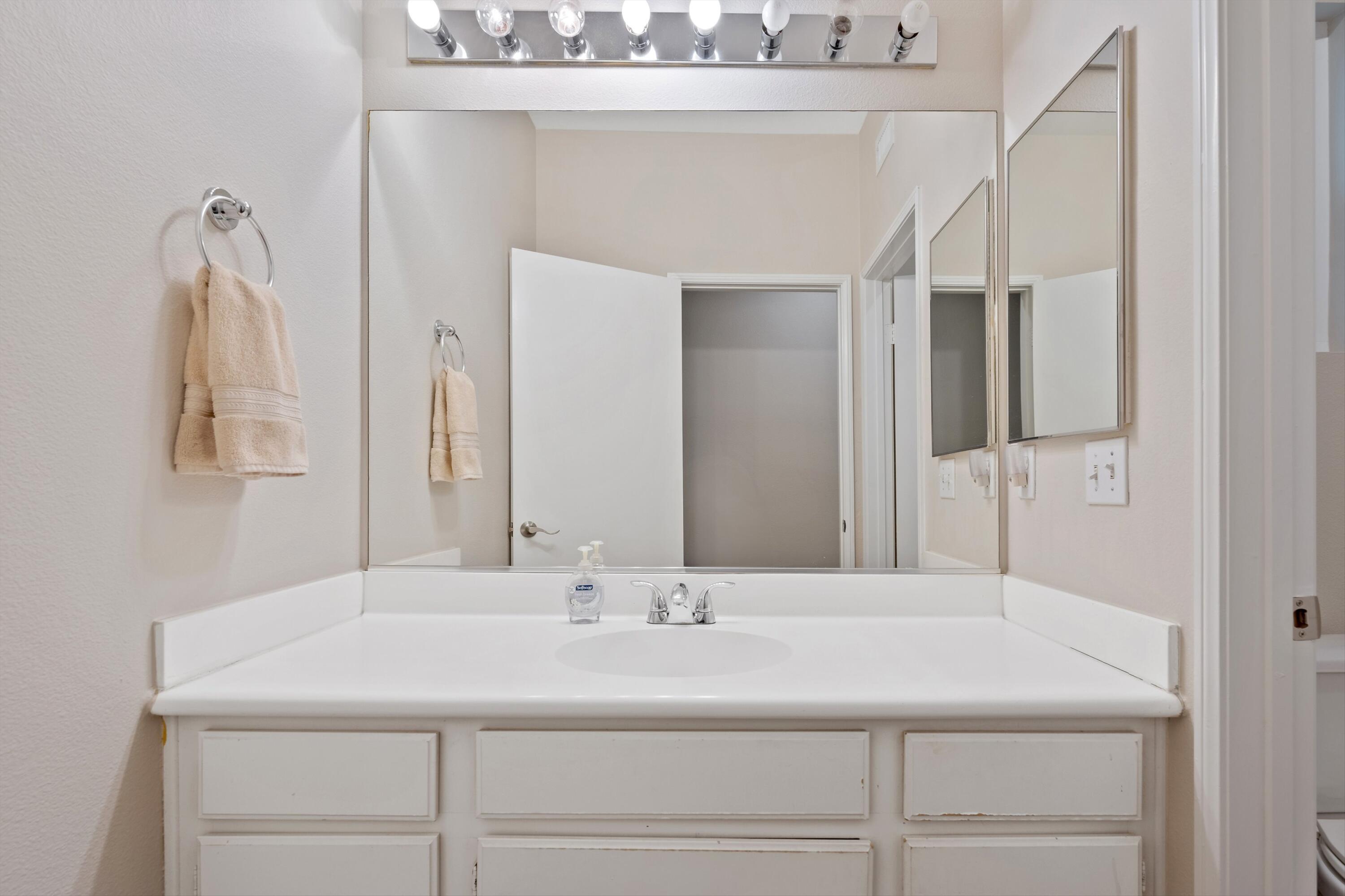 49335 Douglas Street Indio, CA 92201 - Photo 30 of 31 a bathroom with a sink and a mirror