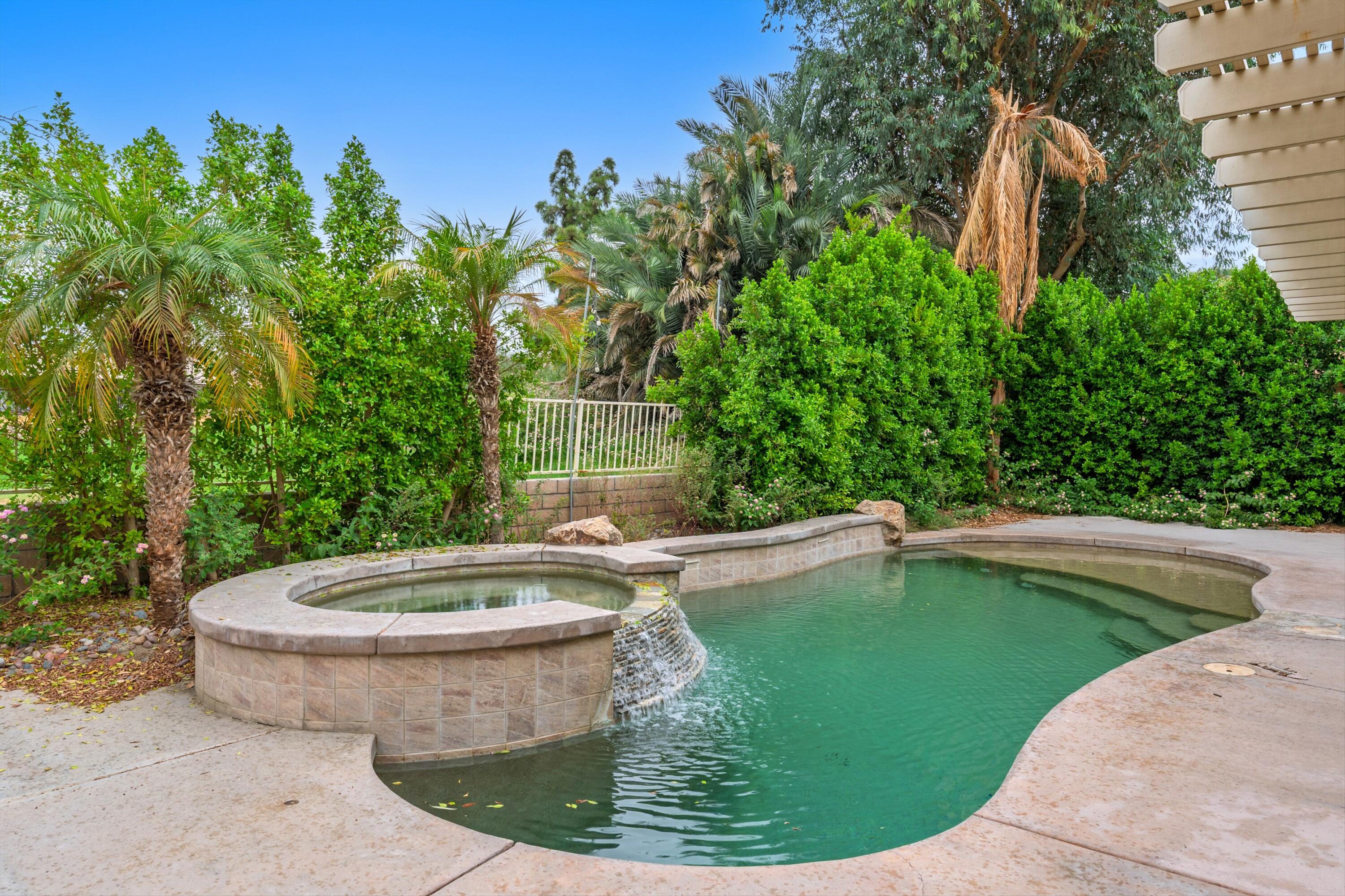 49335 Douglas Street Indio, CA 92201 - Photo 8 of 31 a view of a swimming pool with a outdoor seating