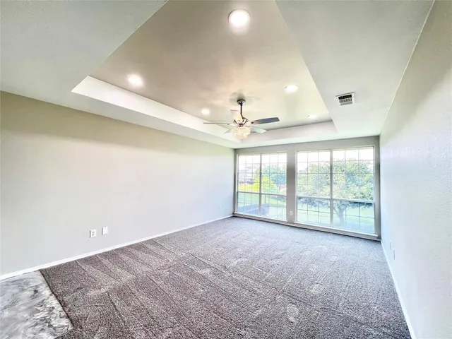 a large white kitchen with a sink and a stove top oven