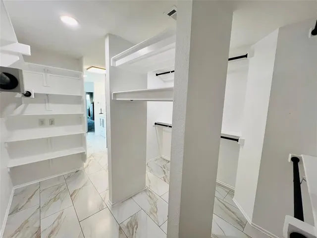 a bathroom with a shower and a wooden floor