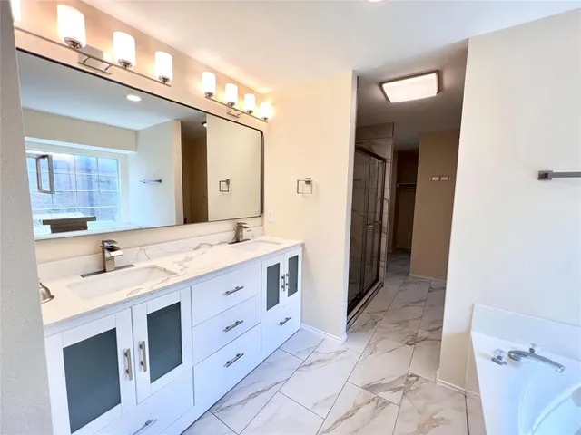 an empty room with windows and cabinet