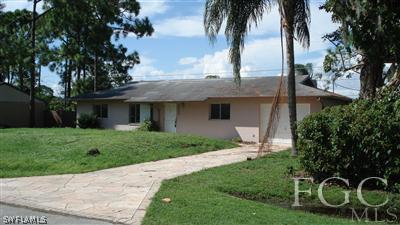 9089 Temple Road West Fort Myers, FL 33967 - Photo 1 of 5 a front view of a house with garden