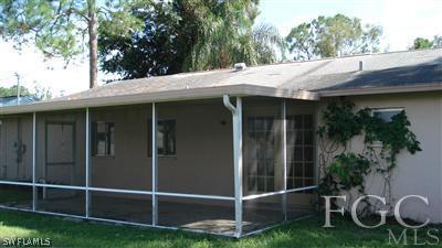9089 Temple Road West Fort Myers, FL 33967 - Photo 4 of 5 a backyard of a house with table and chairs