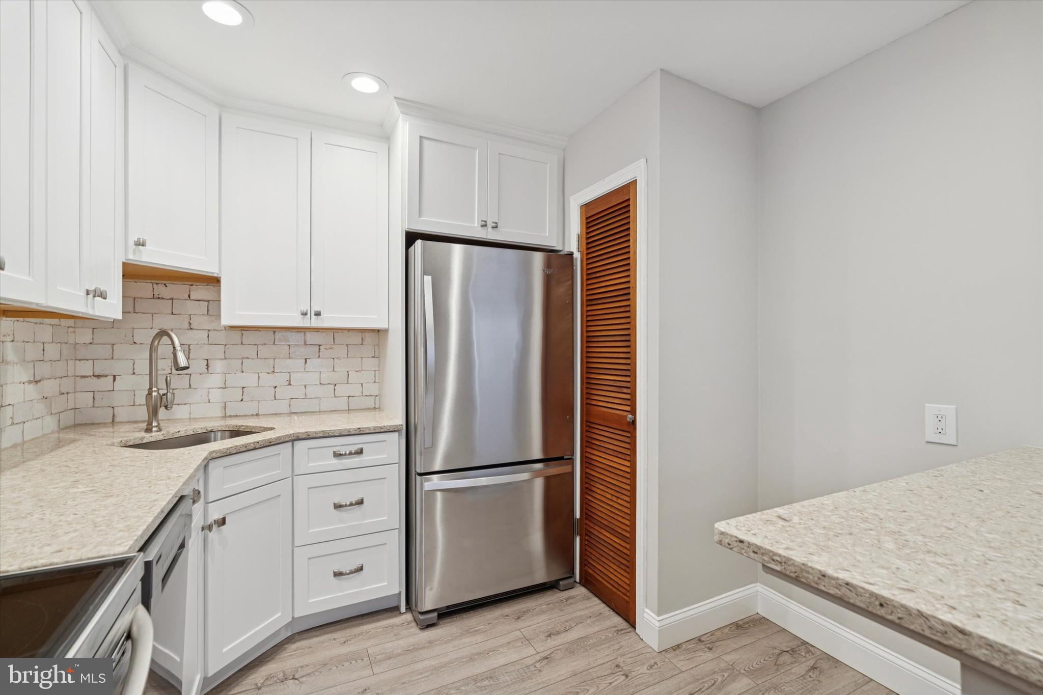 508 Stidman Drive, Unit C1 Springfield, PA 19064 - Photo 11 of 21 a kitchen with white cabinets and stainless steel appliances