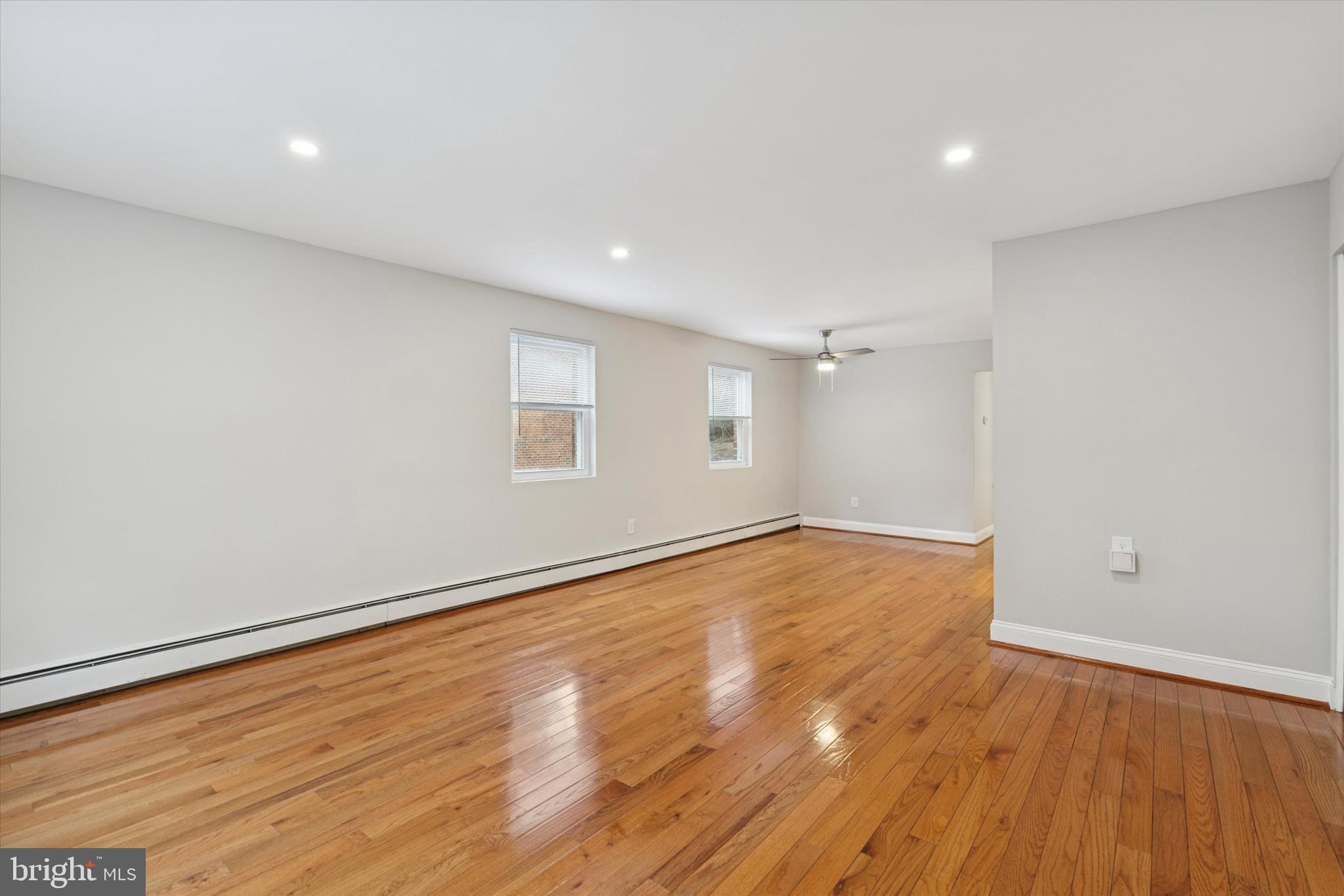 508 Stidman Drive, Unit C1 Springfield, PA 19064 - Photo 2 of 21 an empty room with wooden floor and windows