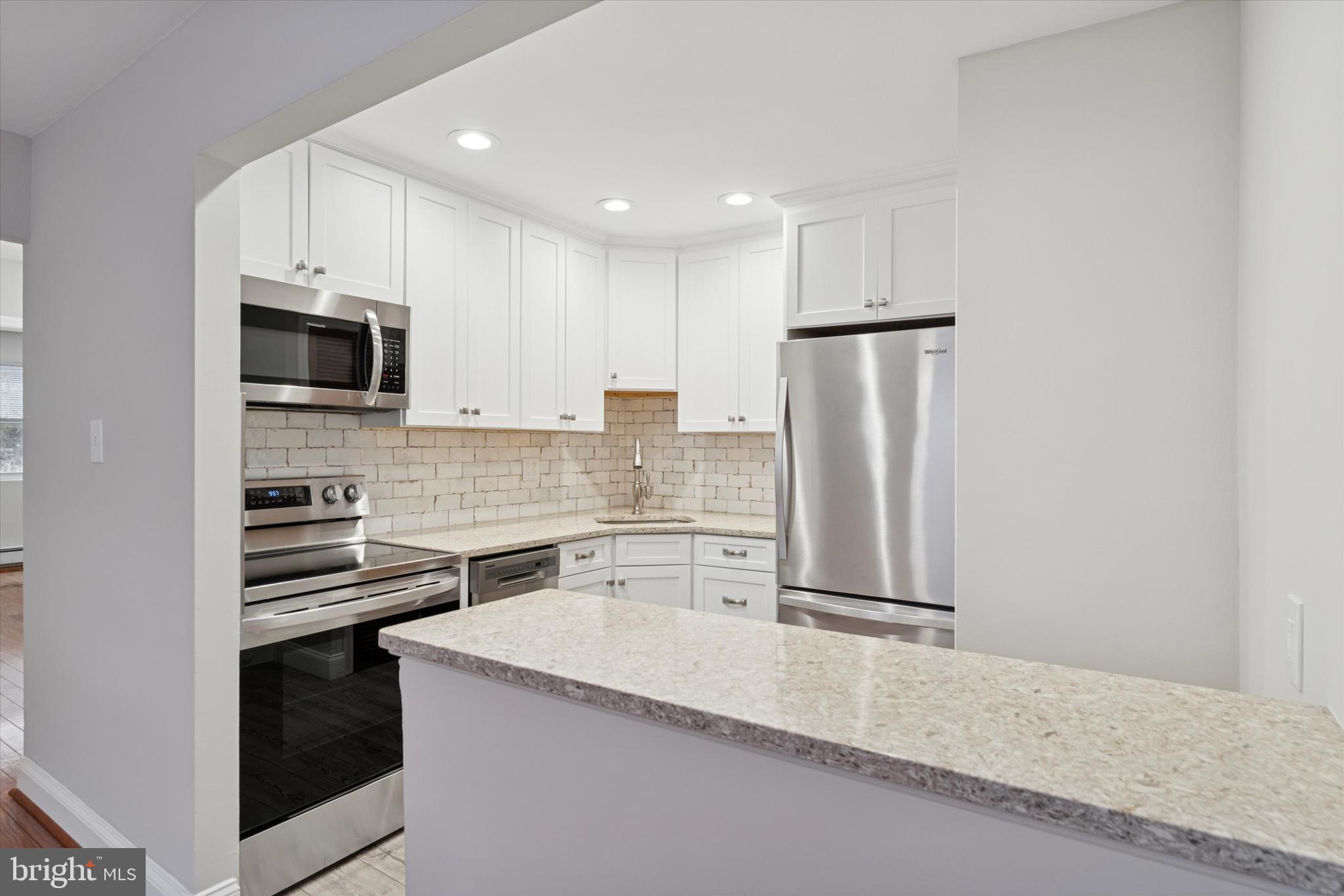 508 Stidman Drive, Unit C1 Springfield, PA 19064 - Photo 10 of 21 a kitchen with a refrigerator stove and microwave