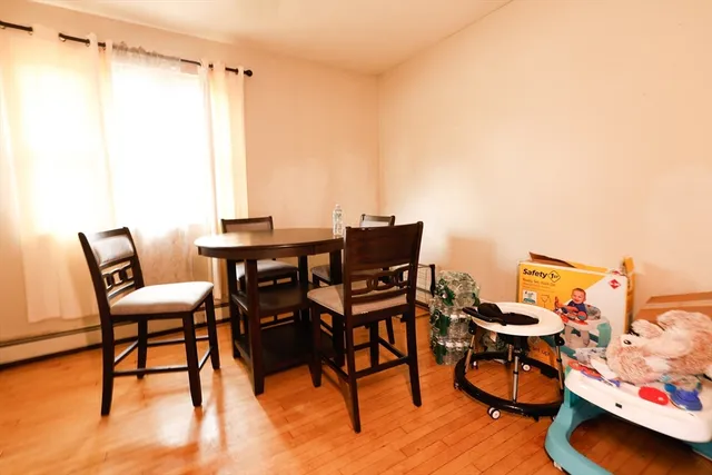 a view of a workspace with furniture and wooden floor