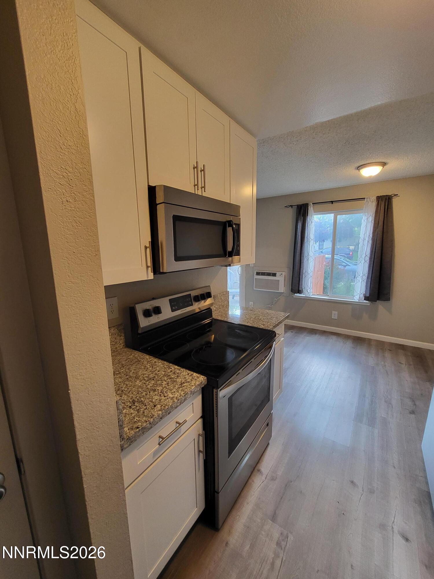 4606 Neil Road, Unit 197 Reno, NV 89502 - Photo 26 of 26 a kitchen with granite countertop a stove and a sink
