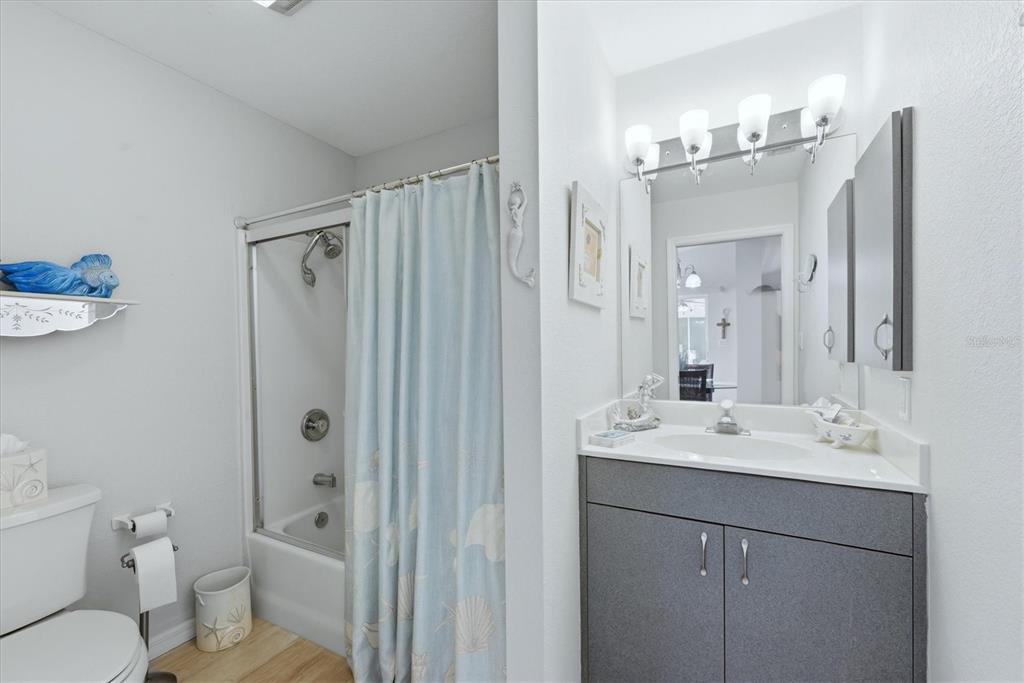 4036 Elvington Road Port Charlotte, FL 33981 - Photo 11 of 29 a bathroom with a sink a toilet a mirror a vanity and shower