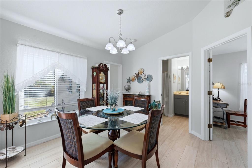 4036 Elvington Road Port Charlotte, FL 33981 - Photo 14 of 29 a view of a dining room with furniture window and wooden floor